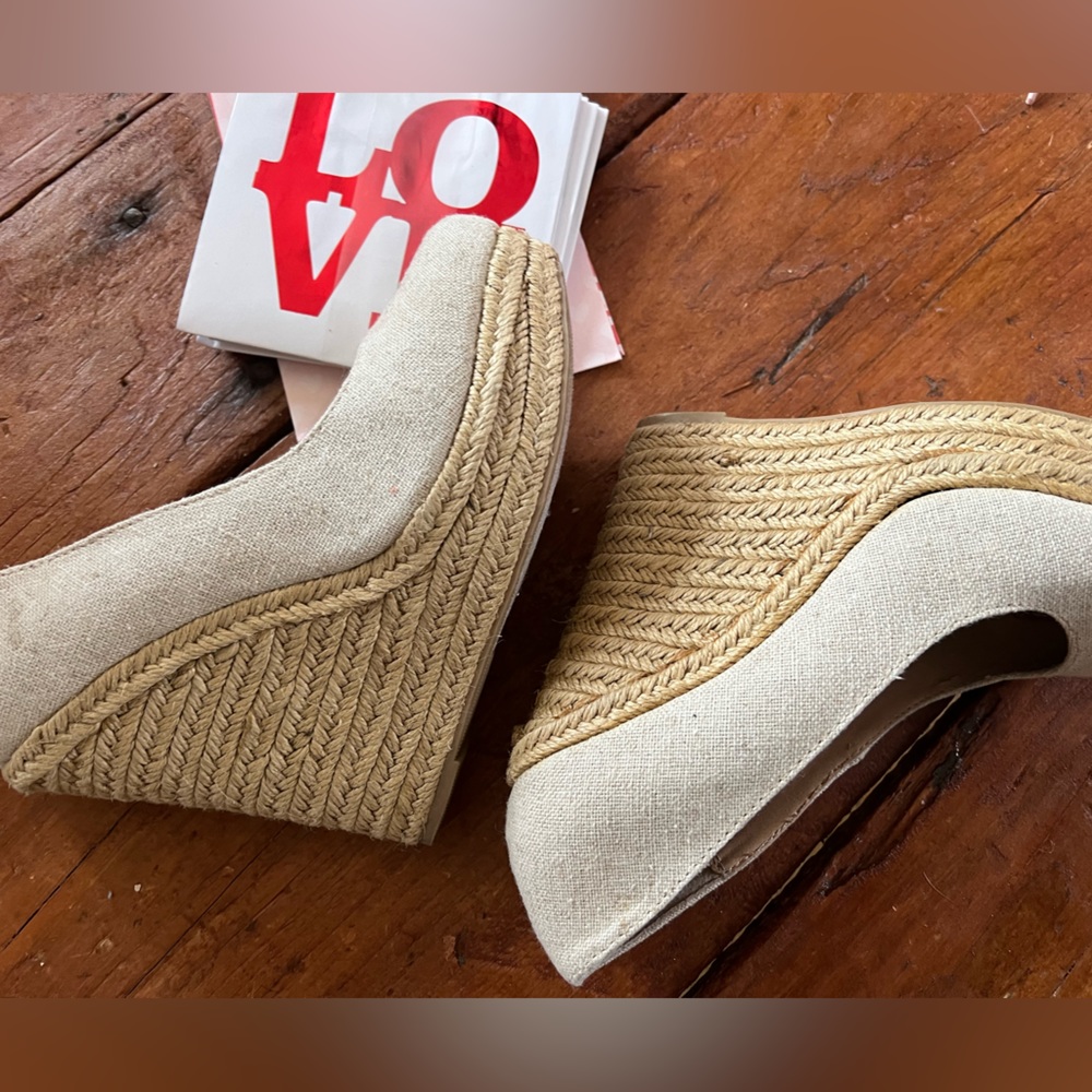 Wedge heels by D. Tan Linen or canvas glue on interior heels from factory.